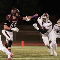 Caravel defensive end Isaac Chukwurah (right) works against Appoquinimink tackle Layton von Brandt in the Jaguars 28-21 DIAA Class 3A football quarterfinal win over the Buccaneers at Appoquinimink High School on Nov. 14, 2025.
