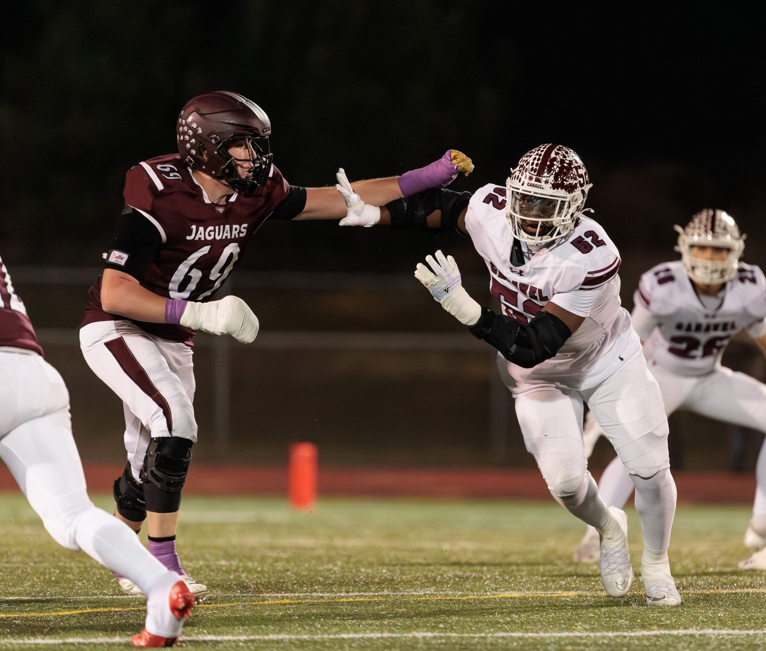 Caravel defensive end Isaac Chukwurah (right) works against Appoquinimink tackle Layton von Brandt in the Jaguars 28-21 DIAA Class 3A football quarterfinal win over the Buccaneers at Appoquinimink High School on Nov. 14, 2025.