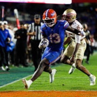 Nov 29, 2025; Gainesville, Florida, USA; Florida Gators running back Jadan Baugh (13) attempts to rush for a touchdown past Florida State Seminoles defensive back Shamar Arnoux (15) during the second half at Ben Hill Griffin Stadium.