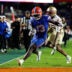 Nov 29, 2025; Gainesville, Florida, USA; Florida Gators running back Jadan Baugh (13) attempts to rush for a touchdown past Florida State Seminoles defensive back Shamar Arnoux (15) during the second half at Ben Hill Griffin Stadium.