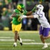 Dec 20, 2025; Eugene, OR, USA; Oregon Ducks running back Jordon Davison (0) rushes and stiff arms James Madison Dukes safety Jacob Thomas (7) during the second quarter at Autzen Stadium.
