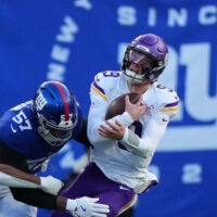 Dec 21, 2025; East Rutherford, New Jersey, USA; New York Giants defensive end Chauncey Golston (57) sacks Minnesota Vikings quarterback J.J. McCarthy (9) during the first half at MetLife Stadium.
