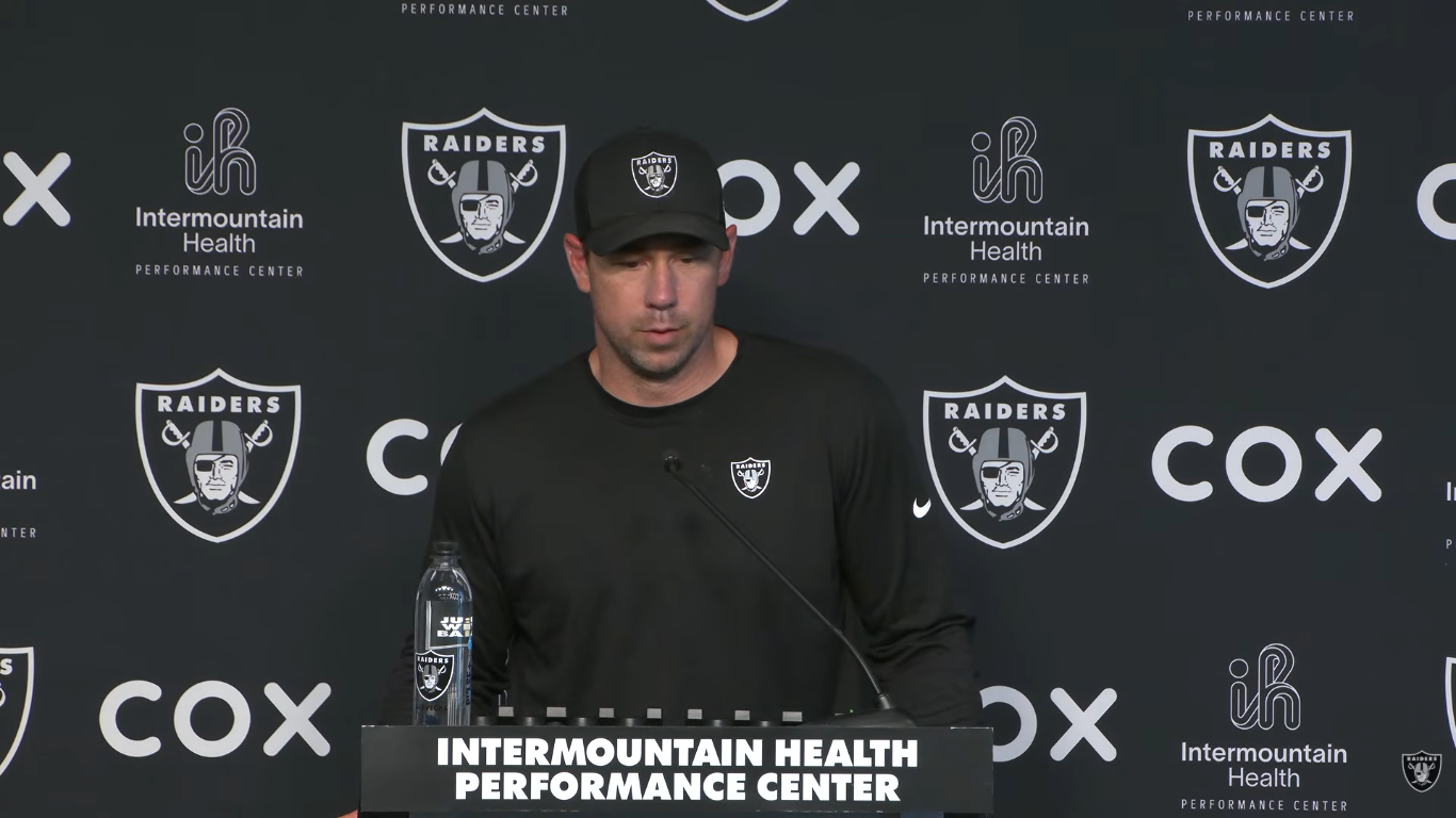 Las Vegas Raiders head coach Klint Kubiak at the podium to talk about defensive back Taron Johnson