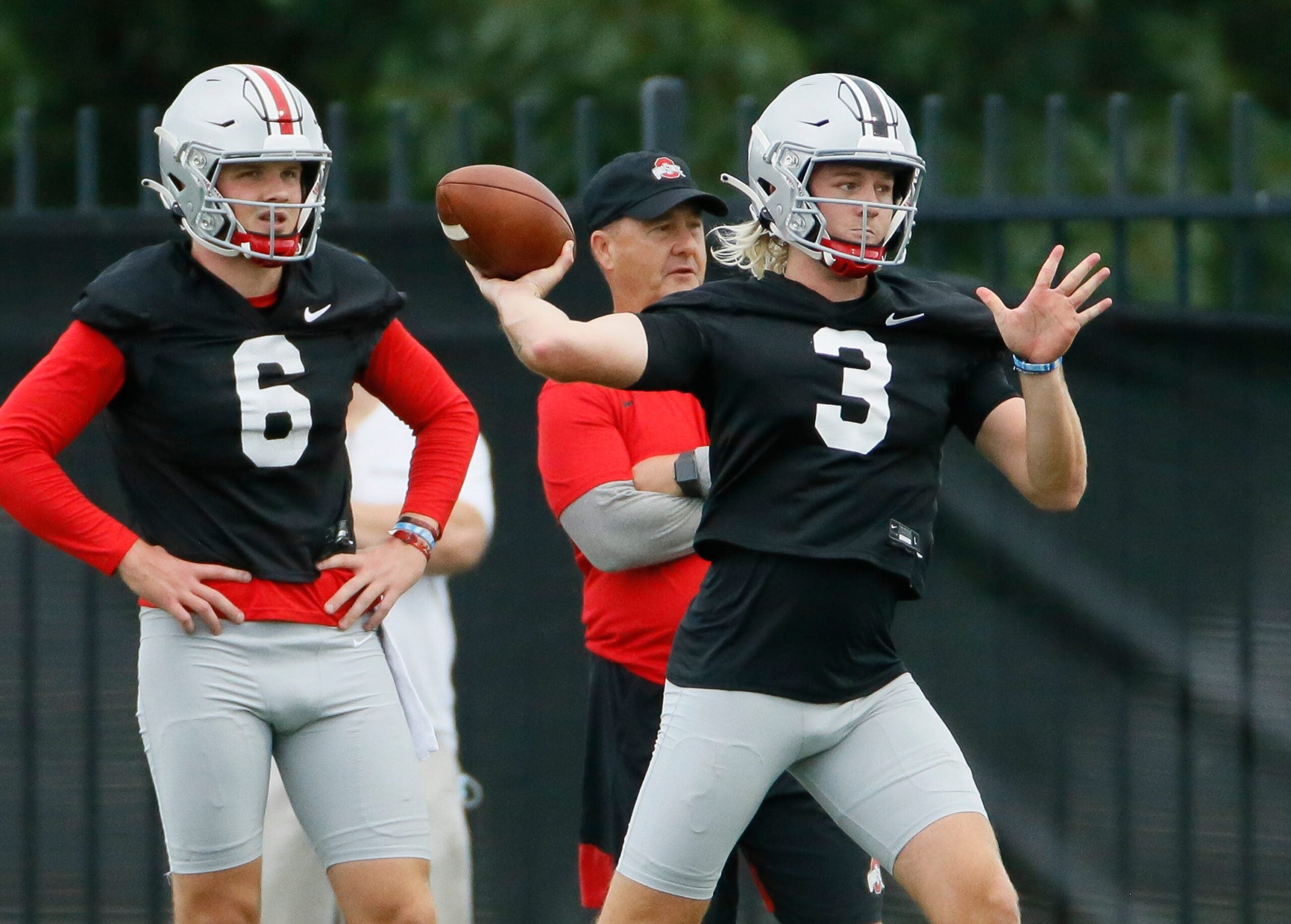 Ohio State Buckeyes quarterback Kyle McCord (6) watches as Quinn Ewers (3) throws during football training camp at the Woody Hayes Athletic Center in Columbus on Wednesday, Aug. 18, 2021.