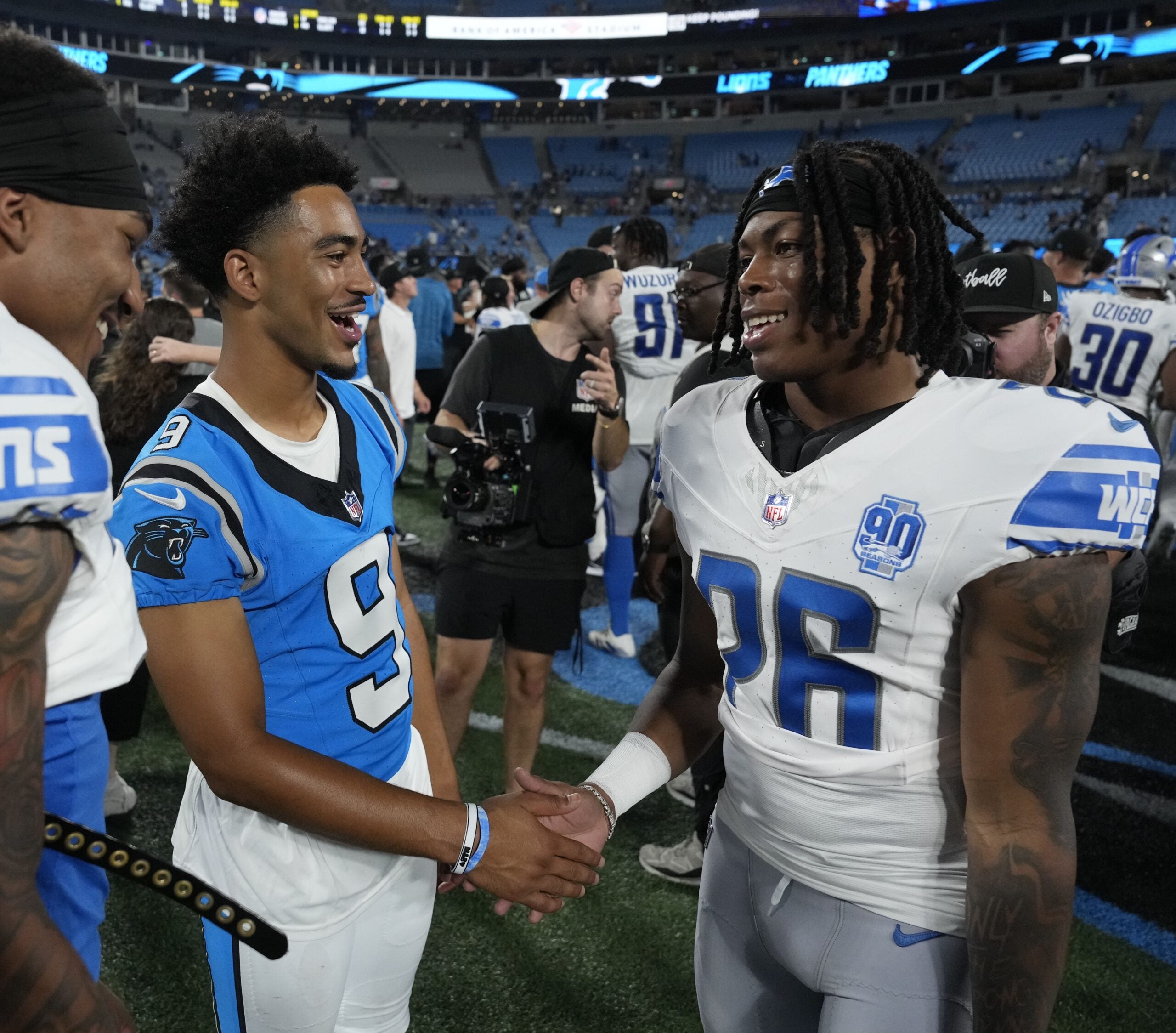 Aug 25, 2023; Charlotte, North Carolina, USA; Carolina Panthers quarterback Bryce Young (9) with Detroit Lions running back Jahmyr Gibbs (26) after the game at Bank of America Stadium.