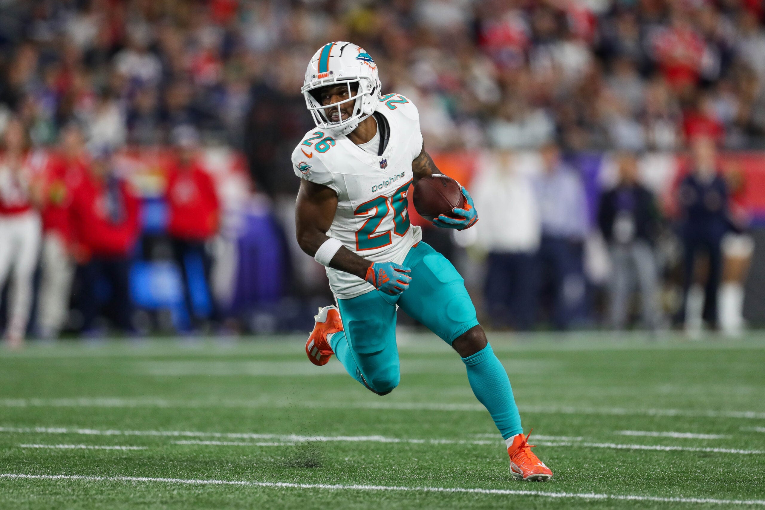 Sep 17, 2023; Foxborough, Massachusetts, USA; Miami Dolphins running back Salvon Ahmed (26) runs the ball during the first half against the New England Patriots at Gillette Stadium.