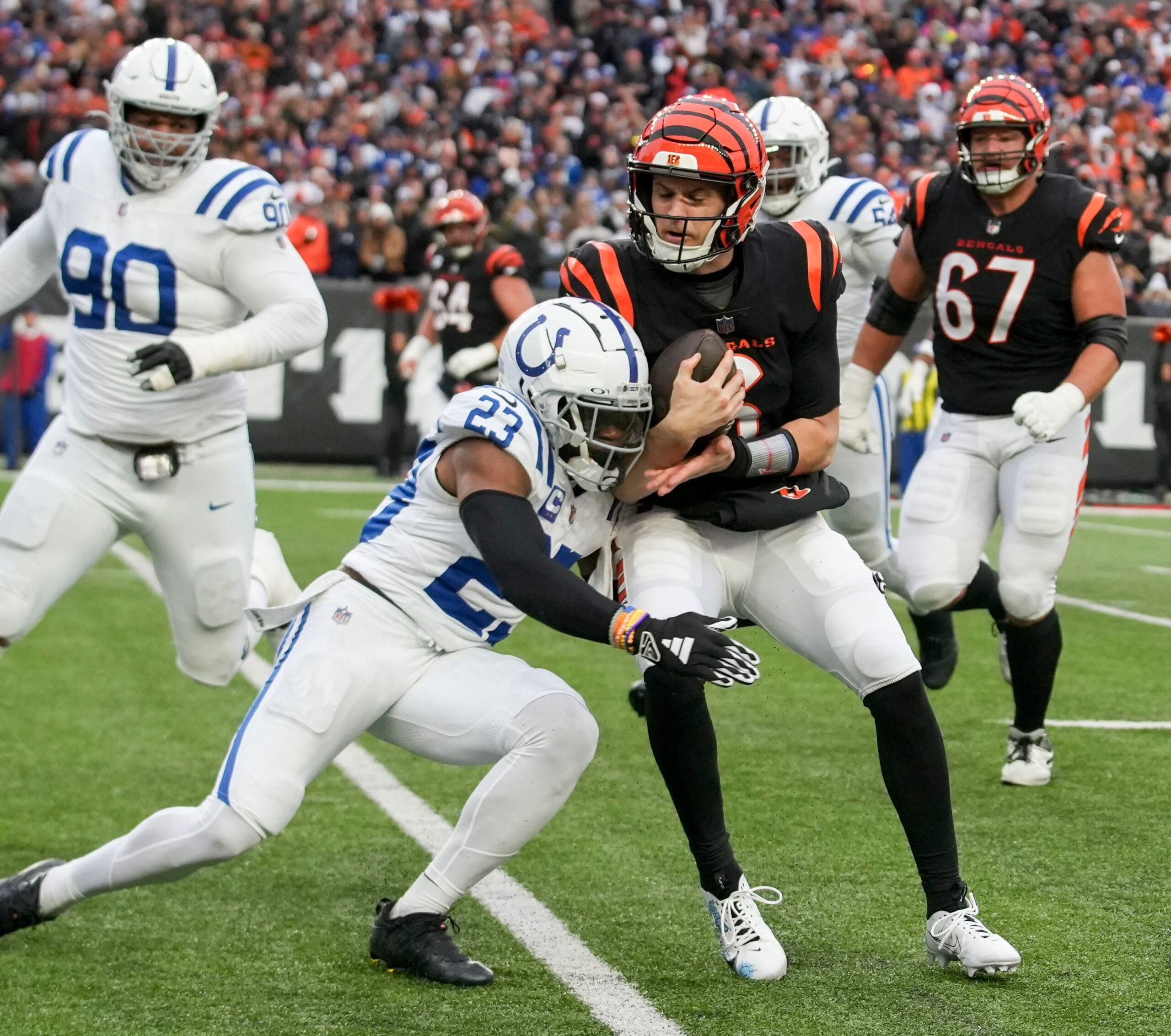 Indianapolis Colts cornerback Kenny Moore II (23) works to bring down Cincinnati Bengals quarterback Jake Browning (6) on Sunday, Dec. 10, 2023, during a game against the Cincinnati Bengals at Paycor Stadium in Cincinnati.