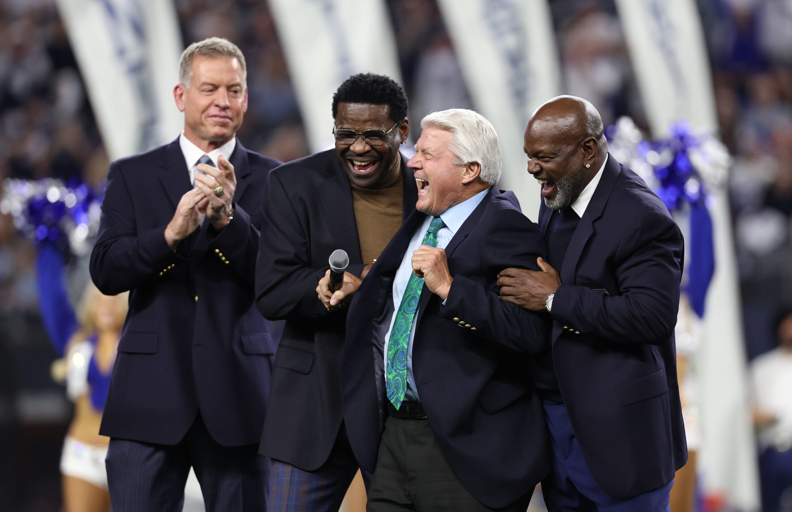 Dec 30, 2023; Arlington, Texas, USA; Dallas Cowboys former head coach Jimmy Johnson laughs with former players Troy Aikman and Michael Irvin and Emmitt Smith after being inducted into the ring of honor at halftime of the game against the Detroit Lions at AT&T Stadium.