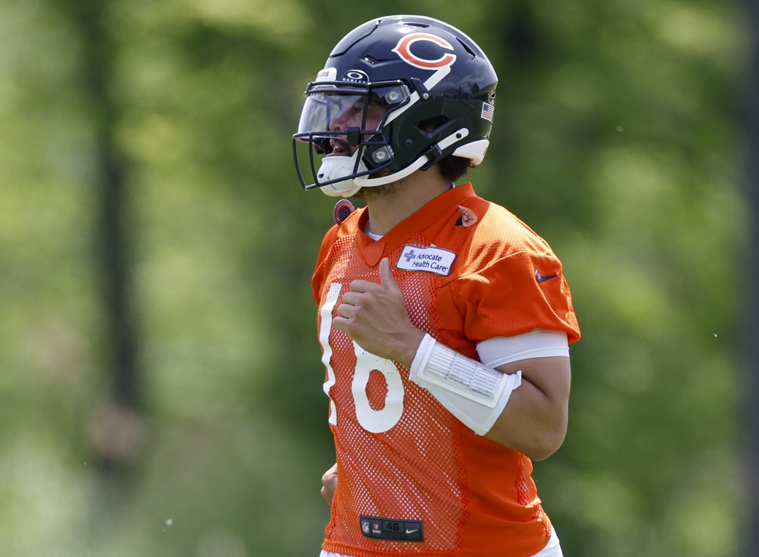May 31, 2024; Lake Forest, IL, USA; Chicago Bears quarterback Caleb Williams (18) runs on the field during organized team activities at Halas Hall.