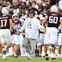Aug 31, 2024; College Station, Texas, USA; Texas A&M Aggies head coach Mike Elko high fives players as they exit the field during the second quarter against the Notre Dame Fighting Irish at Kyle Field.