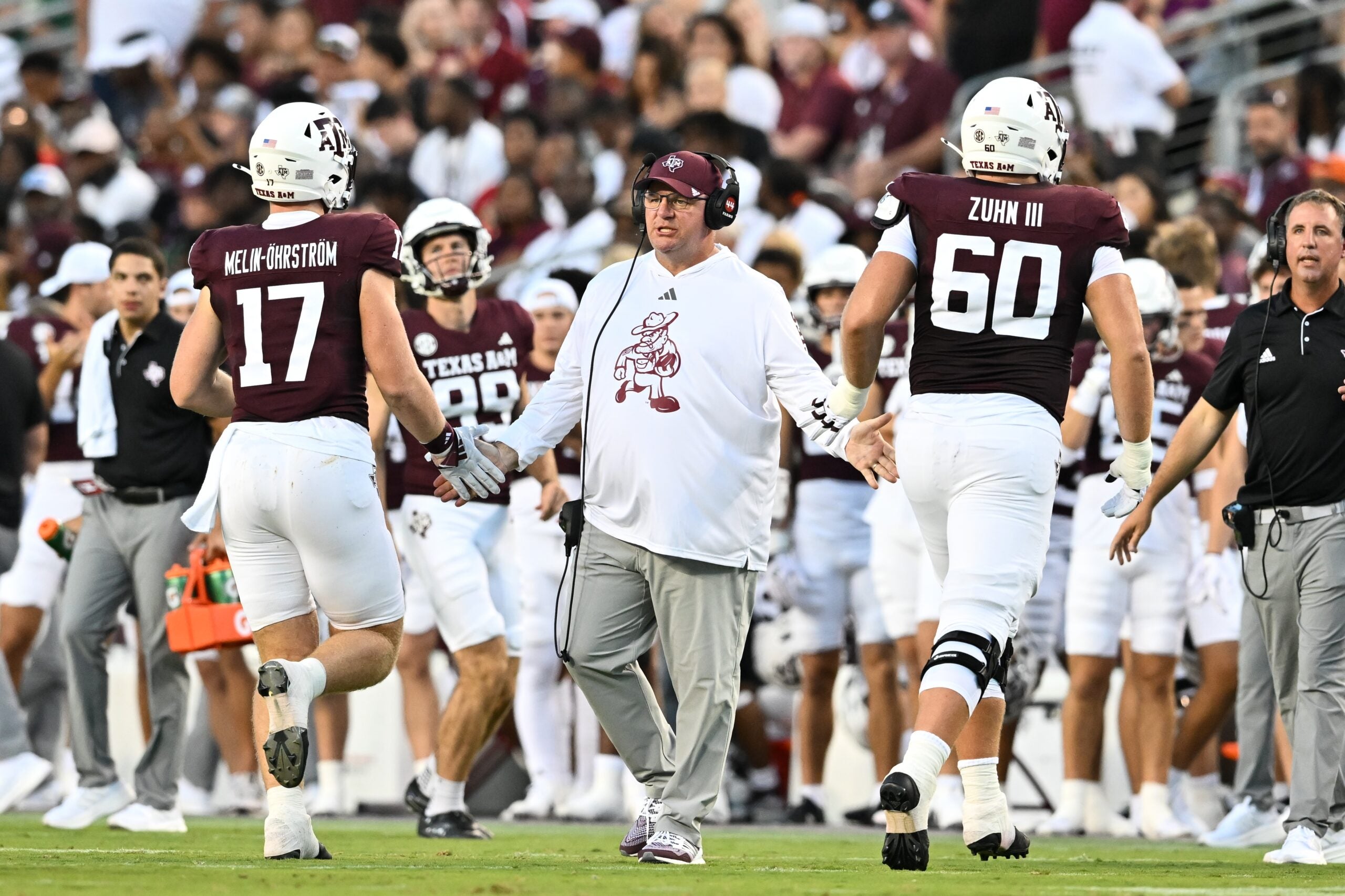 Aug 31, 2024; College Station, Texas, USA; Texas A&M Aggies head coach Mike Elko high fives players as they exit the field during the second quarter against the Notre Dame Fighting Irish at Kyle Field.