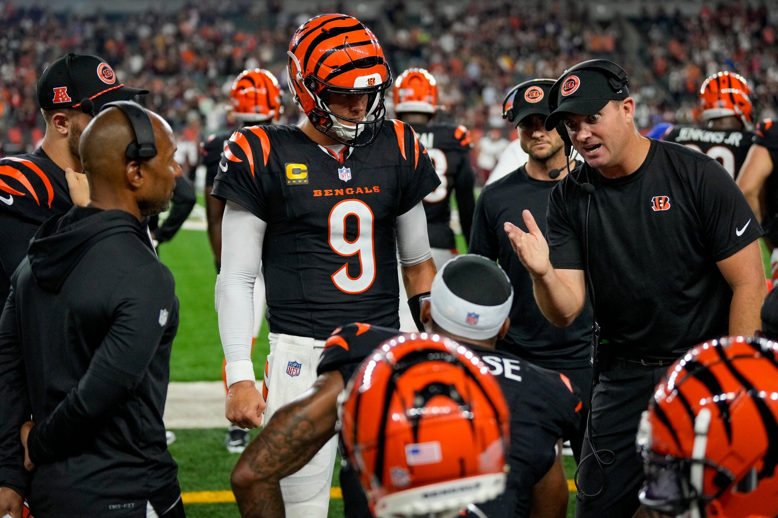 Cincinnati Bengals quarterback Joe Burrow (9) and head coach Zac Taylor talk with wide receiver Ja'Marr Chase (1) on the bench after a drive in the fourth quarter of the NFL Week 3 game between the Cincinnati Bengals and the Washington Commanders at Paycor Stadium in downtown Cincinnati on Monday, Sept. 23, 2024. The Bengals remain winless after a 38-33 loss to Washington.