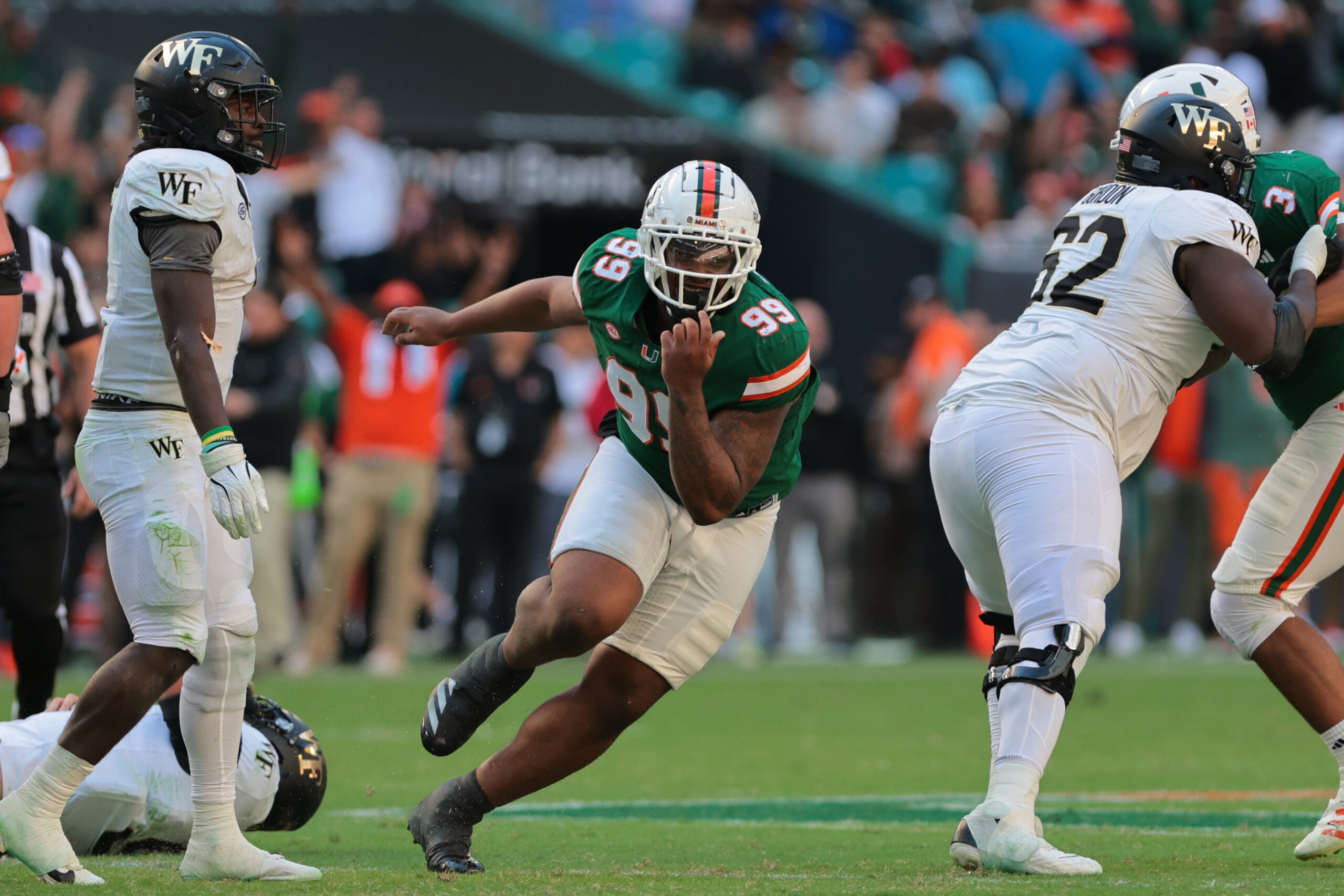 Nov 23, 2024; Miami Gardens, Florida, USA; Miami Hurricanes defensive lineman Ahmad Moten Sr. (99) reacts after sacking Wake Forest Demon Deacons quarterback Hank Bachmeier (not pictured) during the third quarter at Hard Rock Stadium.