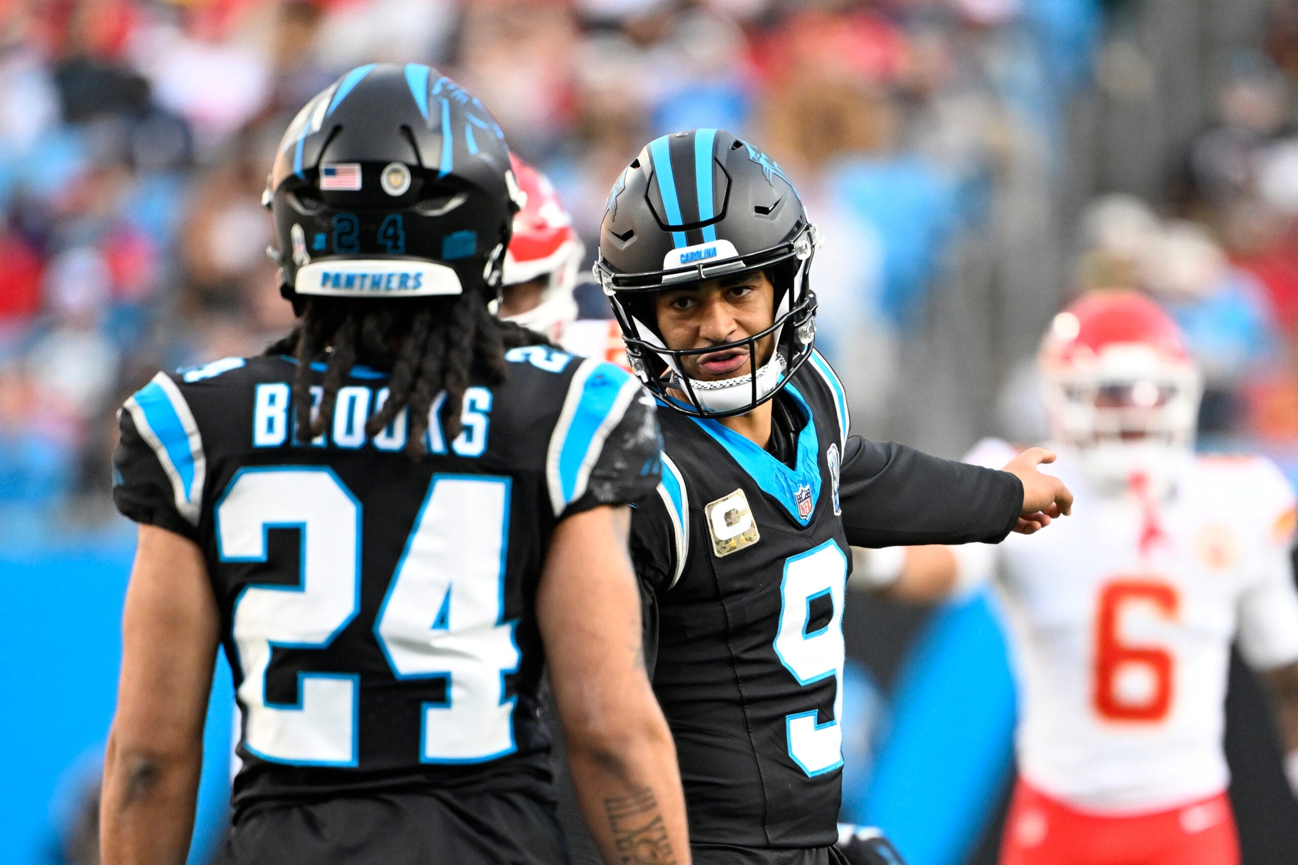 Nov 24, 2024; Charlotte, North Carolina, USA; Carolina Panthers quarterback Bryce Young (9) talks to running back Jonathon Brooks (24) in the fourth quarter at Bank of America Stadium.