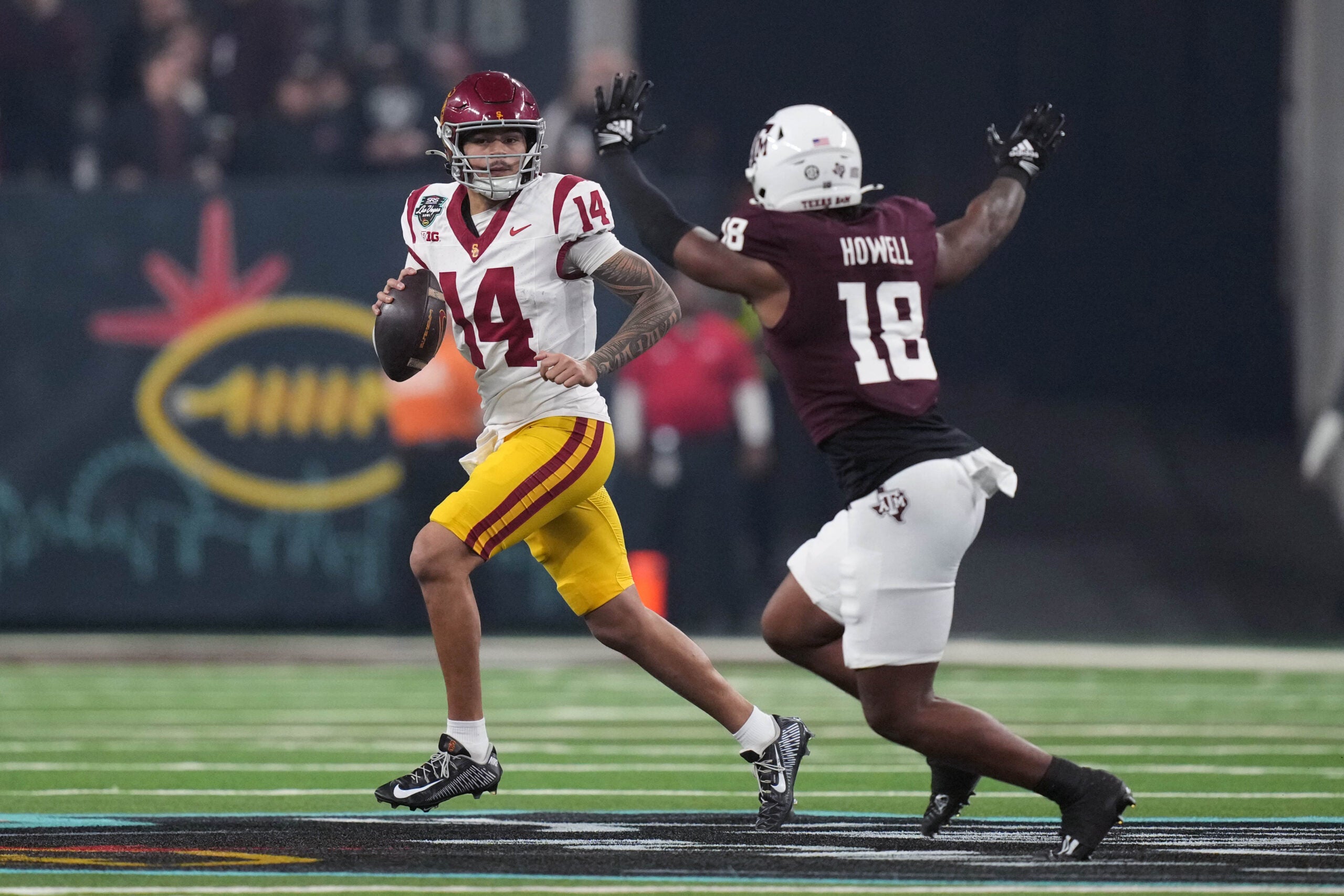 Dec 27, 2024; Las Vegas, NV, USA; Southern California Trojans quarterback Jayden Maiava (14) throws the ball against Texas A&M Aggies defensive lineman Cashius Howell (18) in the first half at Allegiant Stadium.