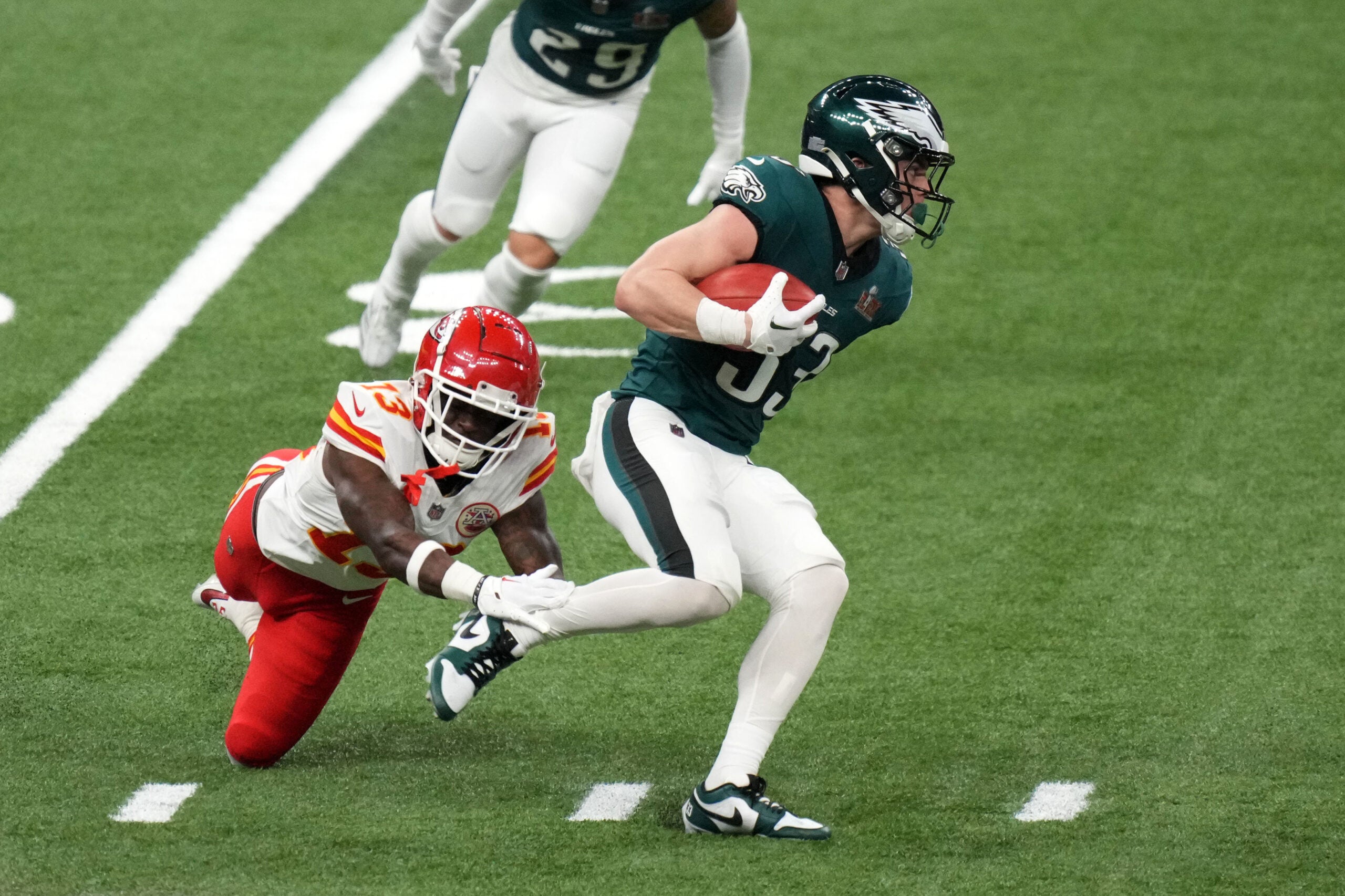 Feb 9, 2025; New Orleans, LA, USA; Philadelphia Eagles cornerback Cooper DeJean (33) returns a punt against Kansas City Chiefs safety Nazeeh Johnson (13) during the second quarter in Super Bowl LIX at Caesars Superdome.