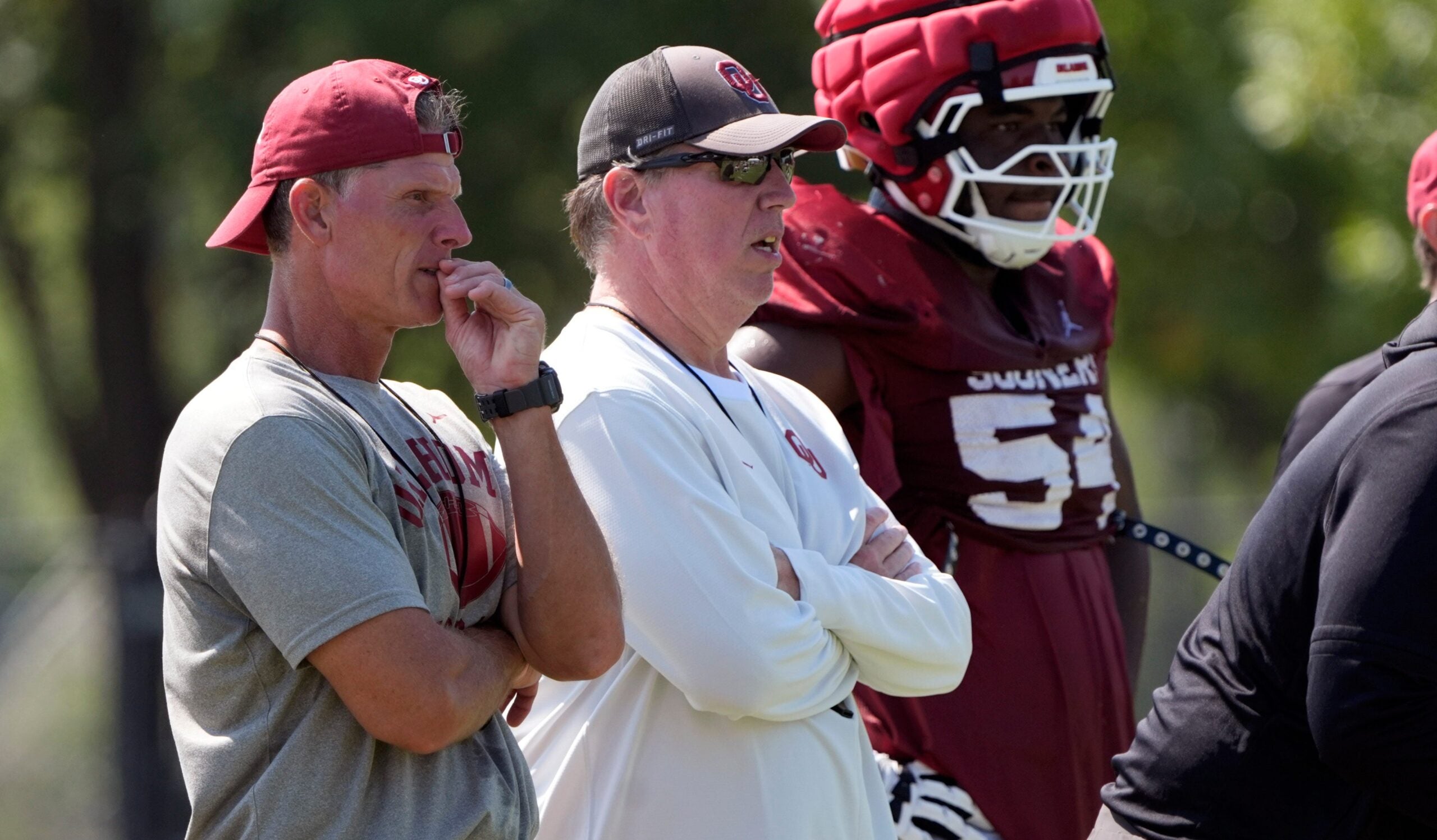 Oklahoma head football coach Brent Venables and Oklahoma offensive line coach Bill Bedenbaugh watch practice during football practice for the University of Oklahoma Sooners in Norman, Okla., Wednesday, Aug., 6, 2025.