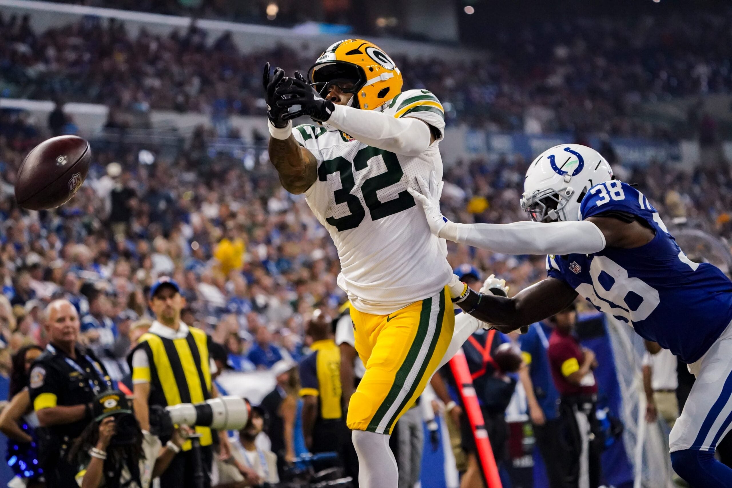 Green Bay Packers running back MarShawn Lloyd (32) and Indianapolis Colts cornerback Chris Lammons (38) miss a long pass on Saturday, Aug. 16, 2025, during a game against the Green Bay Packers at Lucas Oil Stadium in Indianapolis.