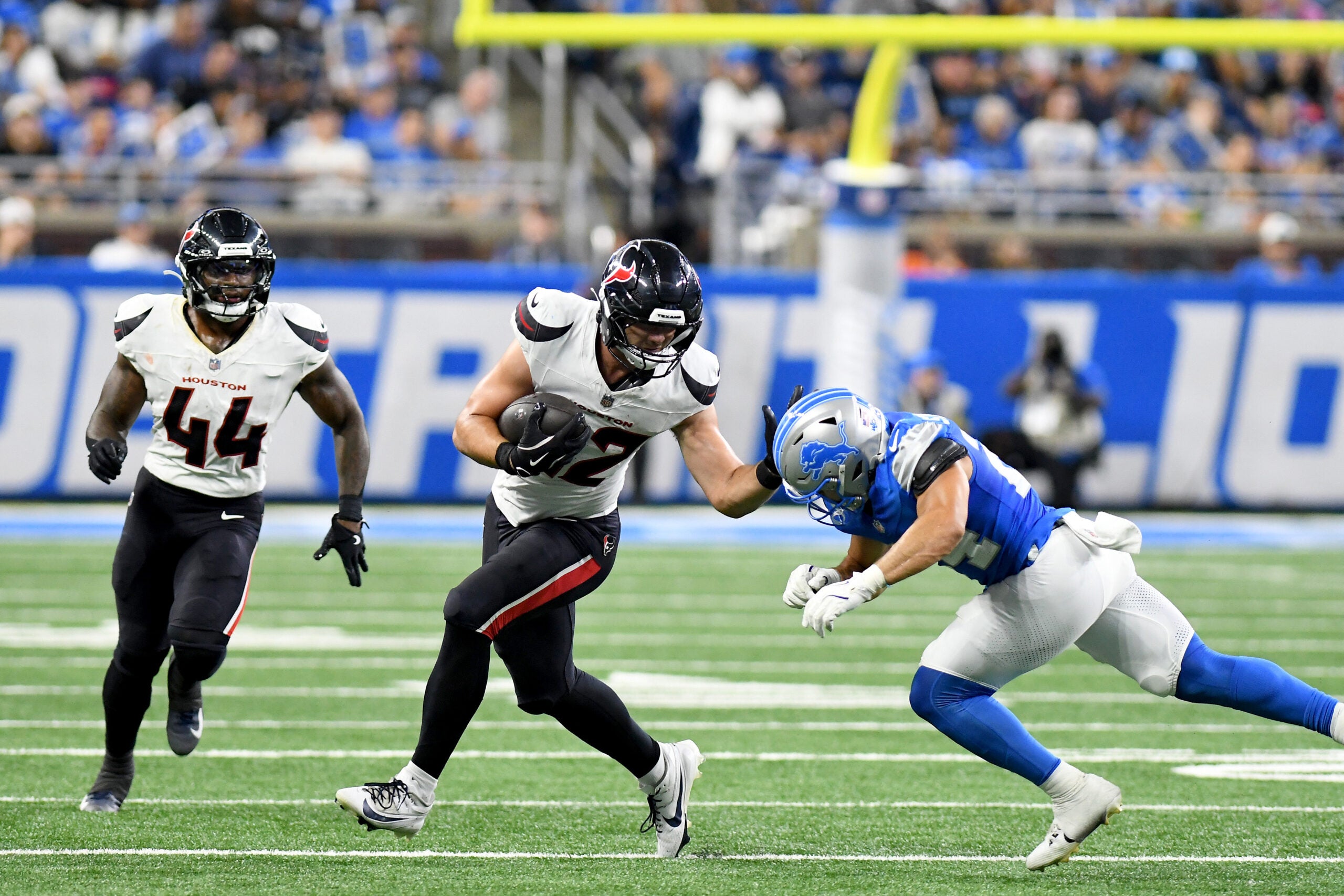 Aug 23, 2025; Detroit, Michigan, USA; Houston Texans tight end Luke Lachey (42) gets tackled by Detroit Lions safety Loren Strickland (24) in third quarter at Ford Field.