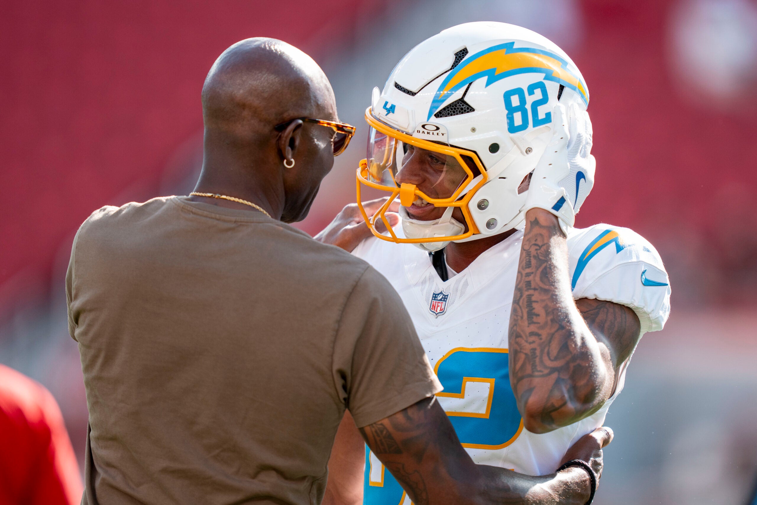 August 23, 2025; Santa Clara, California, USA; Los Angeles Chargers wide receiver Brenden Rice (82) hugs father San Francisco 49ers great Jerry Rice (left) before the game at Levi's Stadium.
