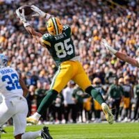 Green Bay Packers tight end Tucker Kraft (85) makes a catch for a touchdown against Detroit Lions safety Brian Branch (32) during the first half at Lambeau Field in Green Bay, Wis., on Sunday, September 7, 2025.