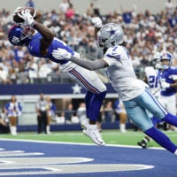 Sep 14, 2025; Arlington, Texas, USA; New York Giants wide receiver Malik Nabers (1) makes a catch for a touchdown against Dallas Cowboys cornerback Trevon Diggs (7) during the second quarter at AT&T Stadium.