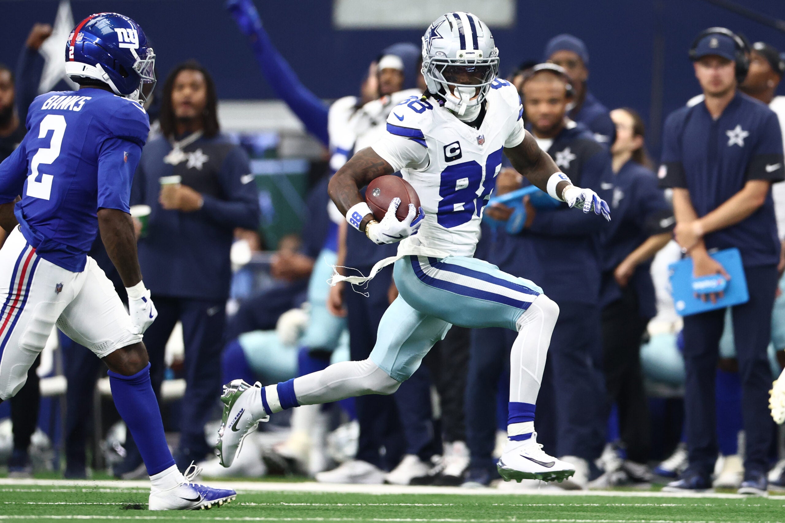 Sep 14, 2025; Arlington, Texas, USA; Dallas Cowboys wide receiver CeeDee Lamb (88) runs with the ball against the New York Giants during the second quarter at AT&T Stadium.