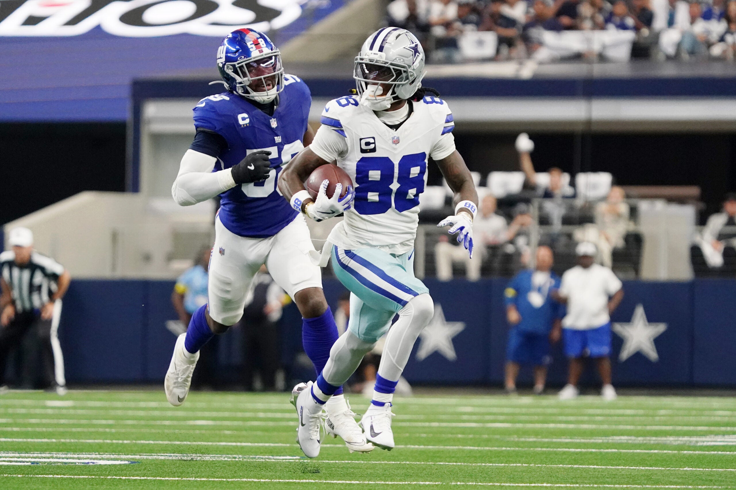Sep 14, 2025; Arlington, Texas, USA; Dallas Cowboys wide receiver CeeDee Lamb (88) runs with the ball against the New York Giants during the second quarter at AT&T Stadium.