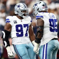 Sep 14, 2025; Arlington, Texas, USA; Dallas Cowboys defensive tackle Osa Odighizuwa (97) celebrates with defensive tackle Kenny Clark (95) after a play against the New York Giants during the second quarter at AT&T Stadium.