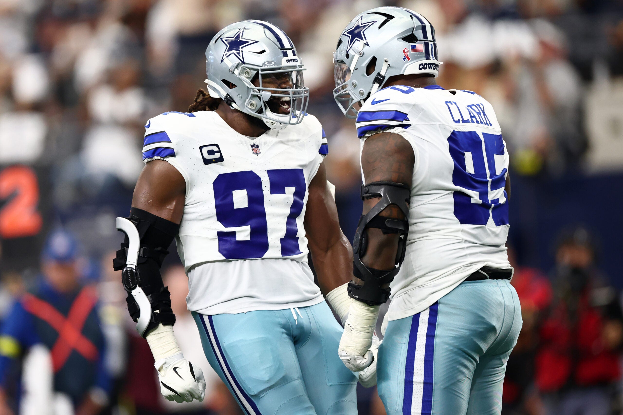 Sep 14, 2025; Arlington, Texas, USA; Dallas Cowboys defensive tackle Osa Odighizuwa (97) celebrates with defensive tackle Kenny Clark (95) after a play against the New York Giants during the second quarter at AT&T Stadium.