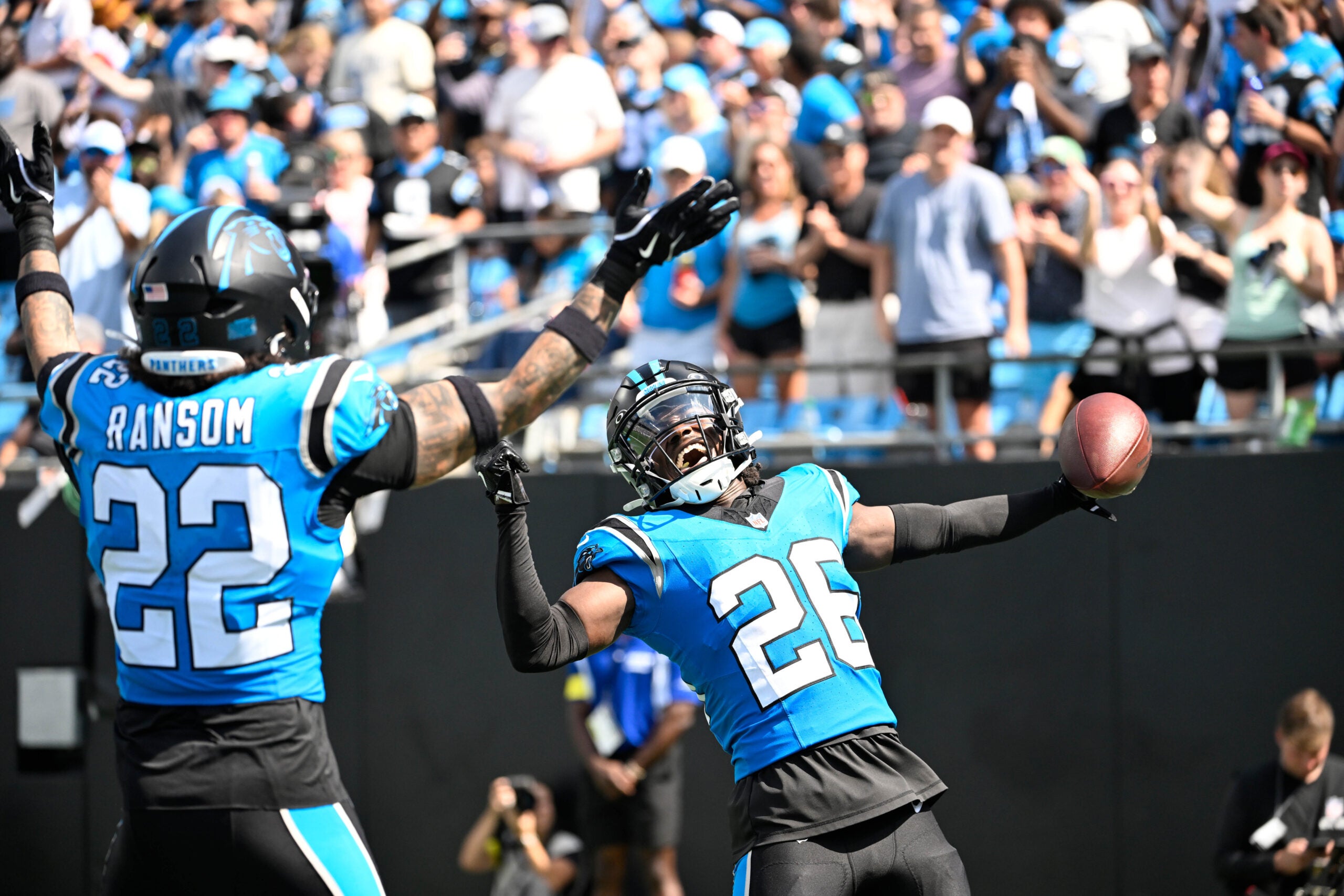 Sep 21, 2025; Charlotte, North Carolina, USA; Carolina Panthers cornerback Chau Smith-Wade (26) celebrates with safety Lathan Ransom (22) after intercepting the ball and scoring a touchdown in the third quarter at Bank of America Stadium.