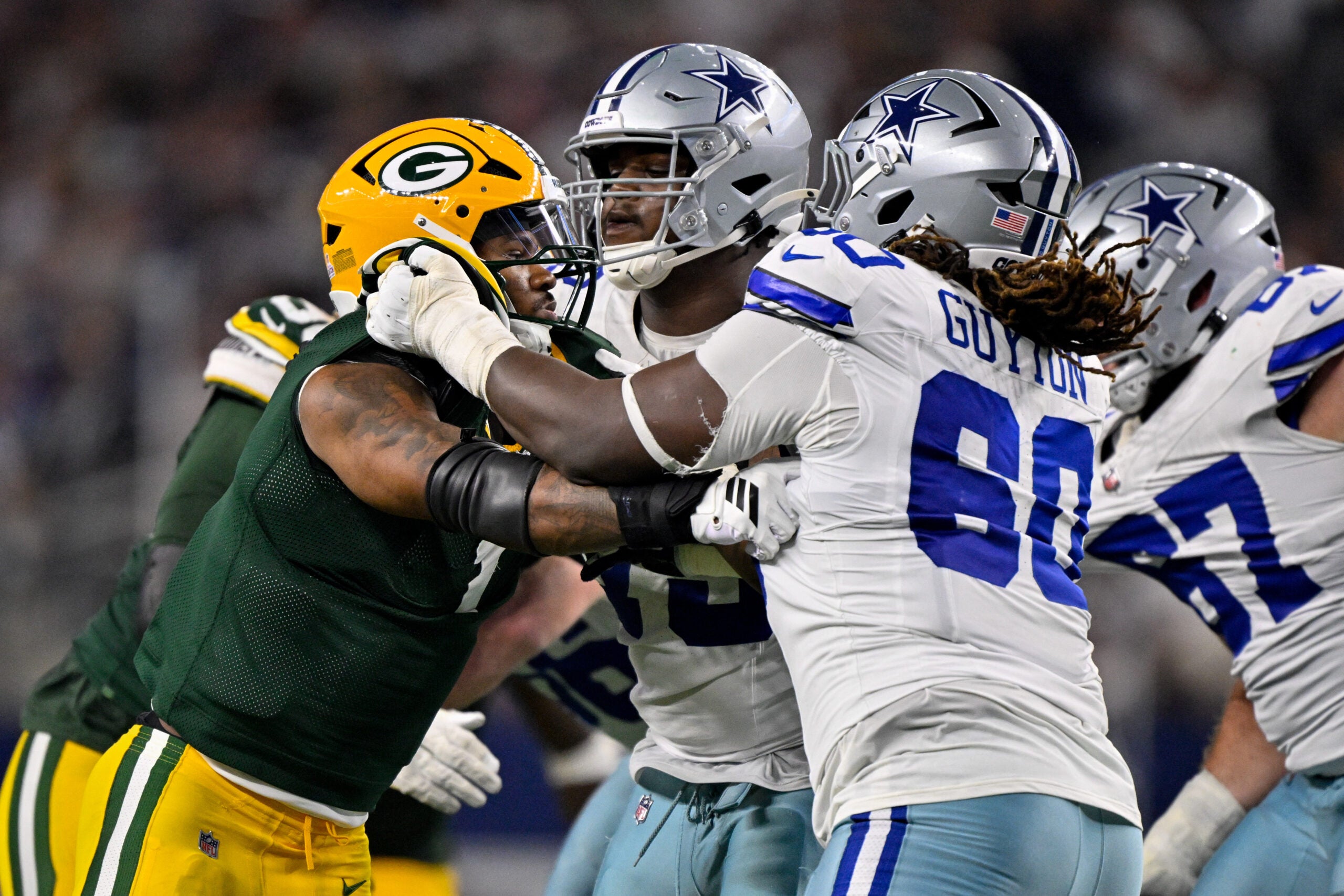 Sep 28, 2025; Arlington, Texas, USA; Dallas Cowboys offensive tackle Tyler Guyton (60) blocks Green Bay Packers defensive end Micah Parsons (1) during the game between the Dallas Cowboys and the Green Bay Packers at AT&T Stadium.