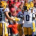 Sep 27, 2025; Oxford, Mississippi, USA; LSU Tigers linebacker West Weeks (33) and safety Tamarcus Cooley (0) react after a defensive stop during the second quarter against the Mississippi Rebels at Vaught-Hemingway Stadium.