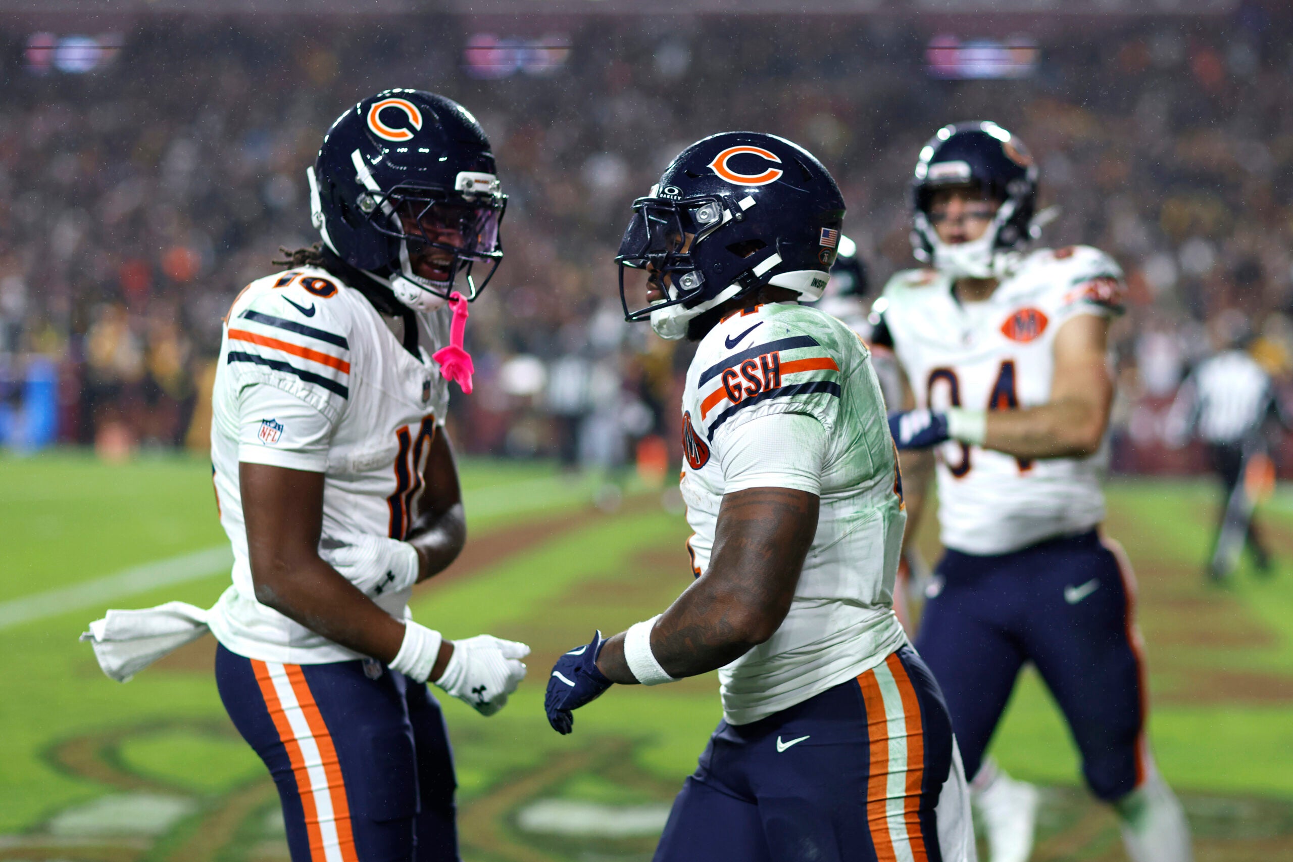 Oct 13, 2025; Landover, Maryland, USA; Chicago Bears running back D'Andre Swift (4) celebrates scoring a touchdown with Luther Burden III (10) during the fourth quarter against the Washington Commanders at Northwest Stadium.