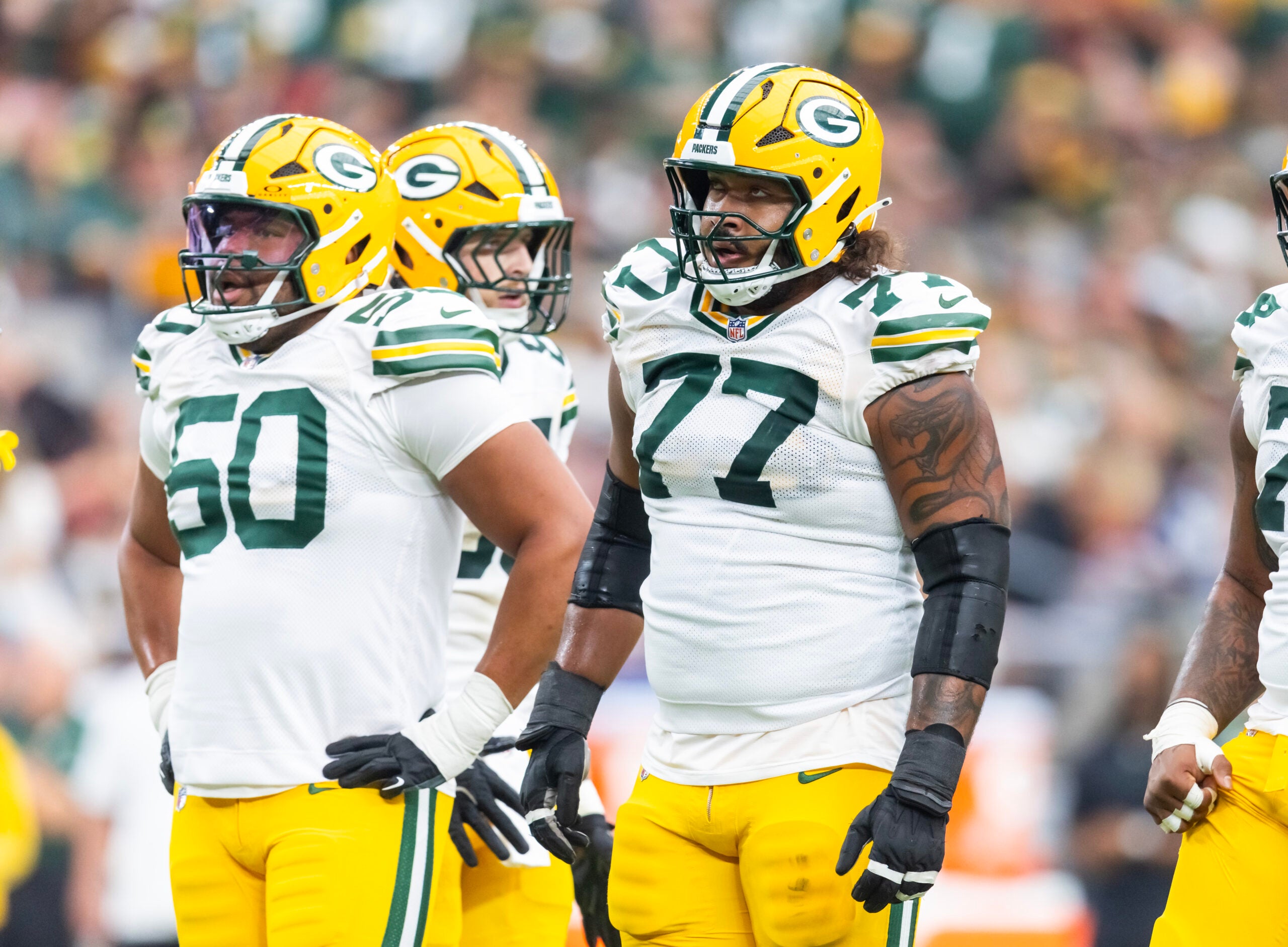 Oct 19, 2025; Glendale, Arizona, USA; Green Bay Packers offensive lineman Zach Tom (50) and guard Jordan Morgan (77) against the Arizona Cardinals at State Farm Stadium.