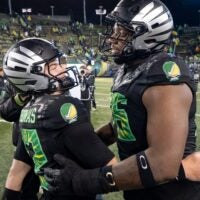 Oregon offensive lineman Isaiah World, right, congratulates Oregon quarterback Brock Thomas as the Oregon Ducks host the Wisconsin Badgers on Oct. 25, 2025, at Autzen Stadium in Eugene, Oregon.