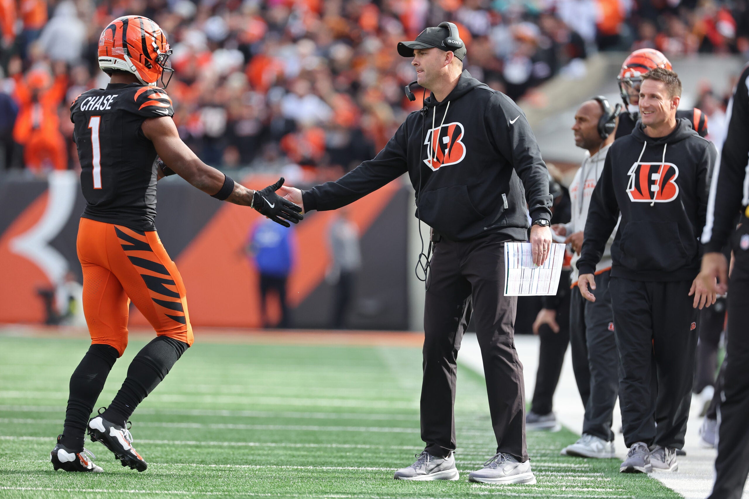 Oct 26, 2025; Cincinnati, Ohio, USA; Cincinnati Bengals wide receiver Ja'Marr Chase (1) shakes hands with head coach Zac Taylor during the fourth quarter against the New York Jets at Paycor Stadium.
