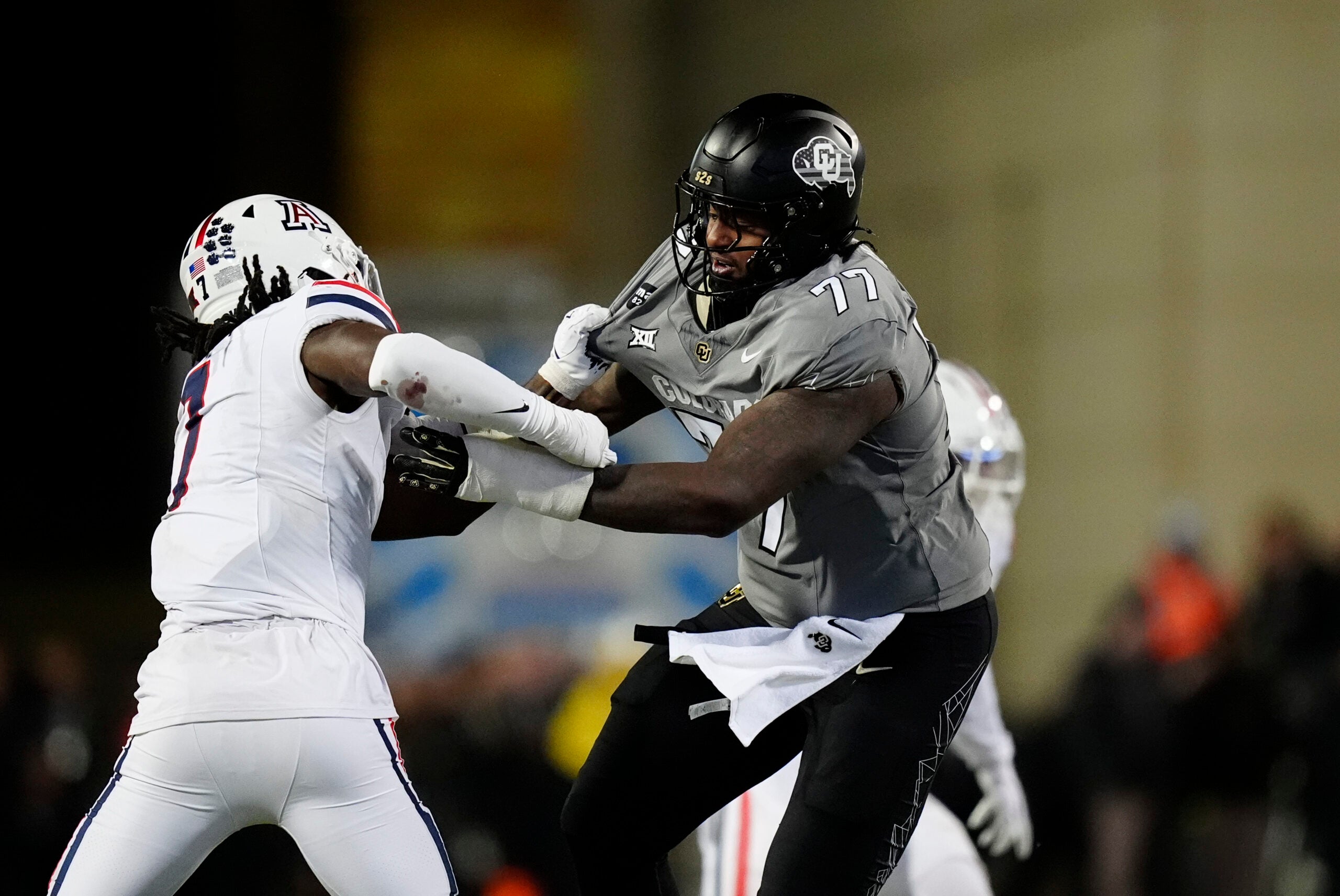 Nov 1, 2025; Boulder, Colorado, USA; Colorado Buffaloes offensive lineman Jordan Seaton (77) and Arizona Wildcats linebacker Chase Kennedy (7) during the second half at Folsom Field.