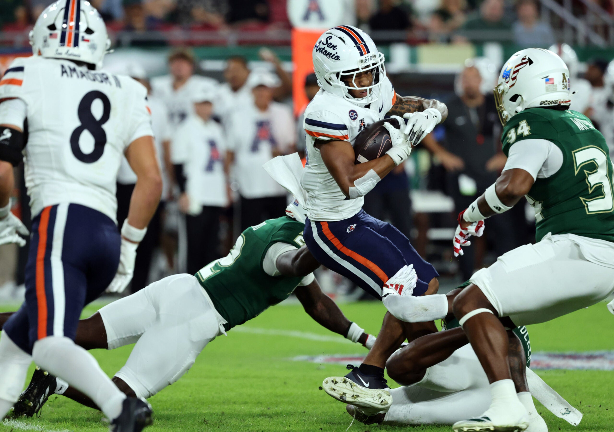 Nov 6, 2025; Tampa, Florida, USA; UTSA Roadrunners running back Will Henderson III (23) runs with the ball as South Florida Bulls cornerback Tavin Ward (2) tackles during the first half at Raymond James Stadium.