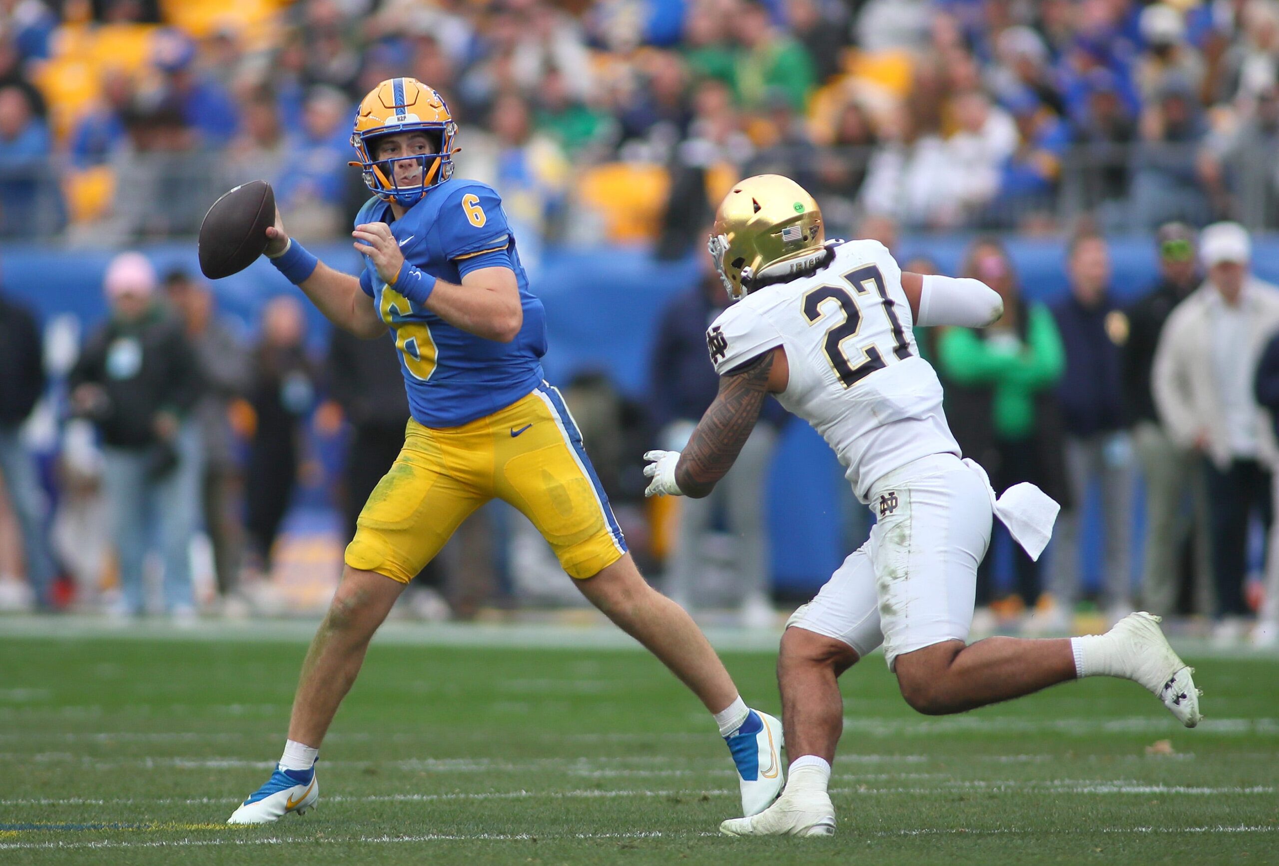 Pittsburgh Panthers quarterback Mason Heintschel (6) prepares to fire the ball downfield while being pressured by Notre Dame Fighting Irish linebacker Kyngstonn Viliamu-Asa (27) during the first half at Acrisure Stadium in Pittsburgh, PA on November 15, 2025.