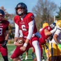 Tabor Academy quarterback Peter Bourque celebrates after scoring a touchdown in the opening drive.