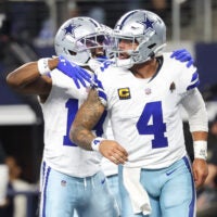 Nov 23, 2025; Arlington, Texas, USA; Dallas Cowboys quarterback Dak Prescott (4) celebrates a touchdown in the fourth quarter against the Philadelphia Eagles at AT&T Stadium.