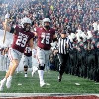 Nov 22, 2025; Missoula, MT, USA; Montana Grizzlies safety Tanner Huff (29) and offensive lineman Liam Brown (79) run on to the field before the game against the Montana State Bobcats at Washington-Grizzly Stadium.