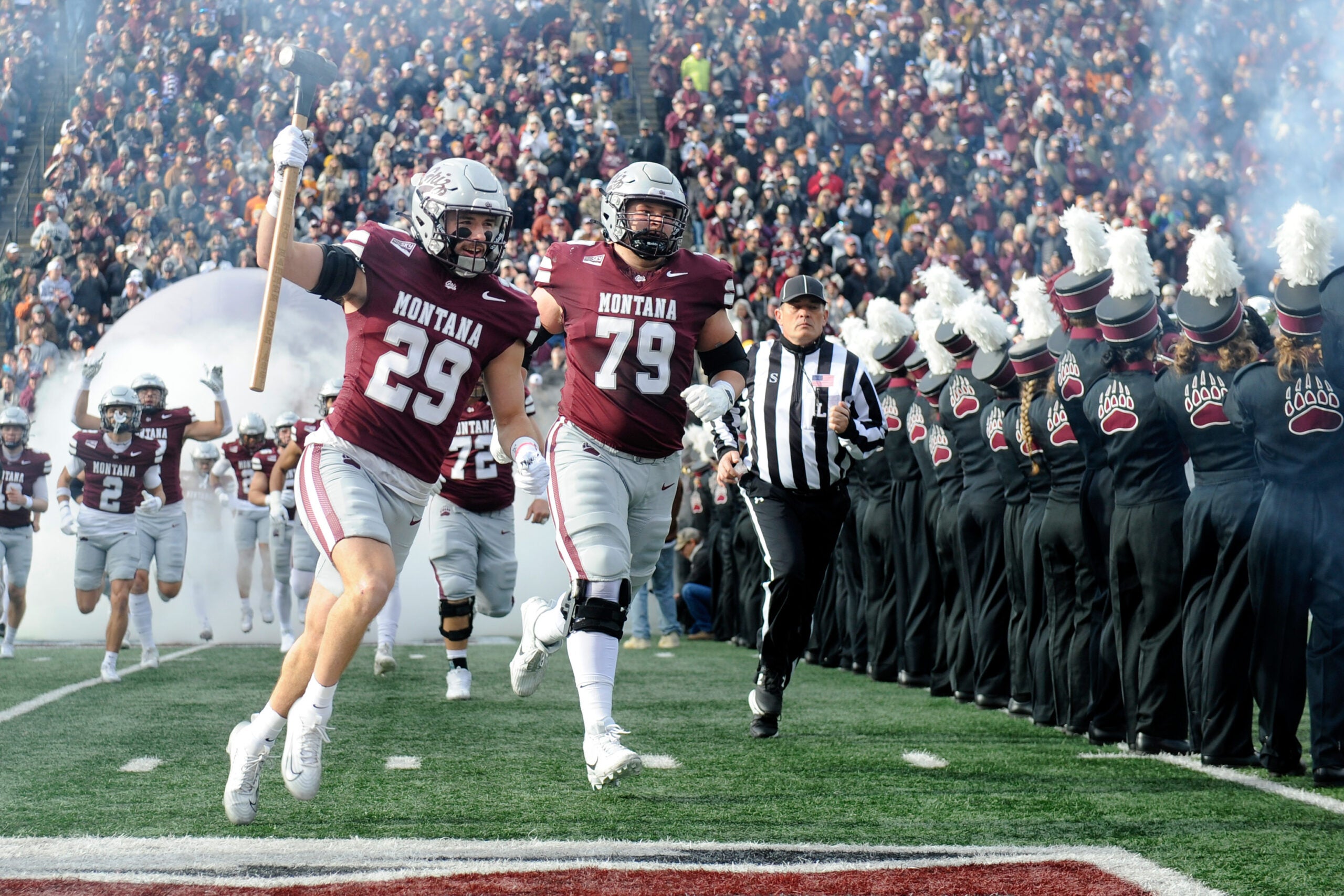 Nov 22, 2025; Missoula, MT, USA; Montana Grizzlies safety Tanner Huff (29) and offensive lineman Liam Brown (79) run on to the field before the game against the Montana State Bobcats at Washington-Grizzly Stadium.