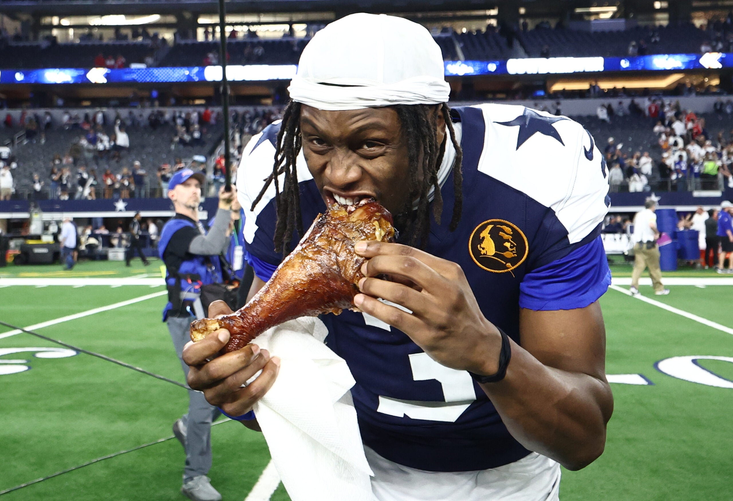 Nov 27, 2025; Arlington, Texas, USA; Dallas Cowboys wide receiver George Pickens (3) celebrates by eating turkey after the game against the Kansas City Chiefs at AT&T Stadium.
