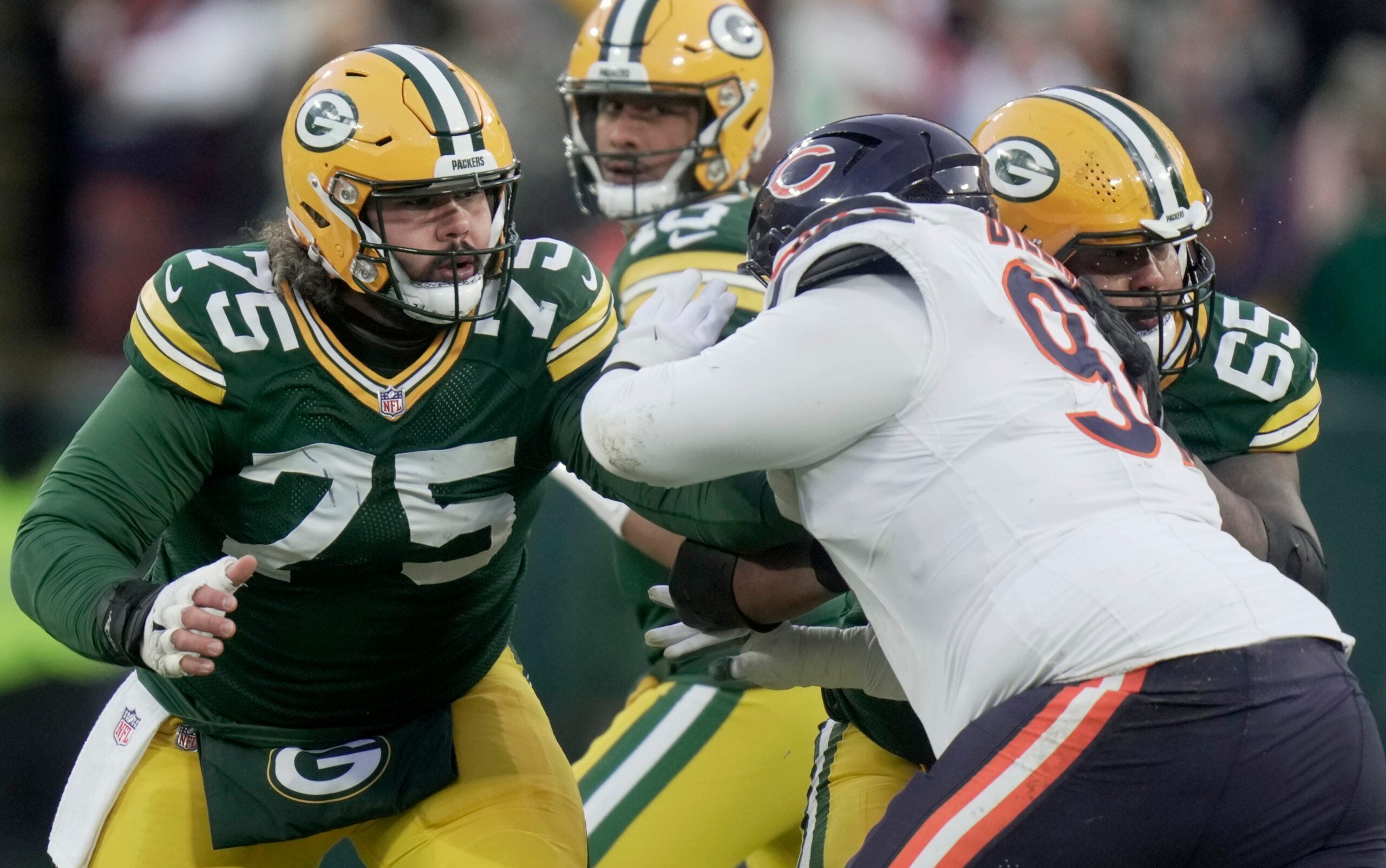 Green Bay Packers' Sean Rhyan (75) blocks Chicago Bears defensive tackle Andrew Billings (97) while providing pass protection during the first quarter of their game Sunday, December 7, 2025 at Lambeau Field in Green Bay, Wisconsin.