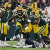 Green Bay Packers defensive end Karl Brooks (94) reacts after tackling Chicago Bears wide receiver DJ Moore (2) for a loss on Sunday, December 7, 2025, at Lambeau Field in Green Bay, Wis. The Packers won the game, 28-21.