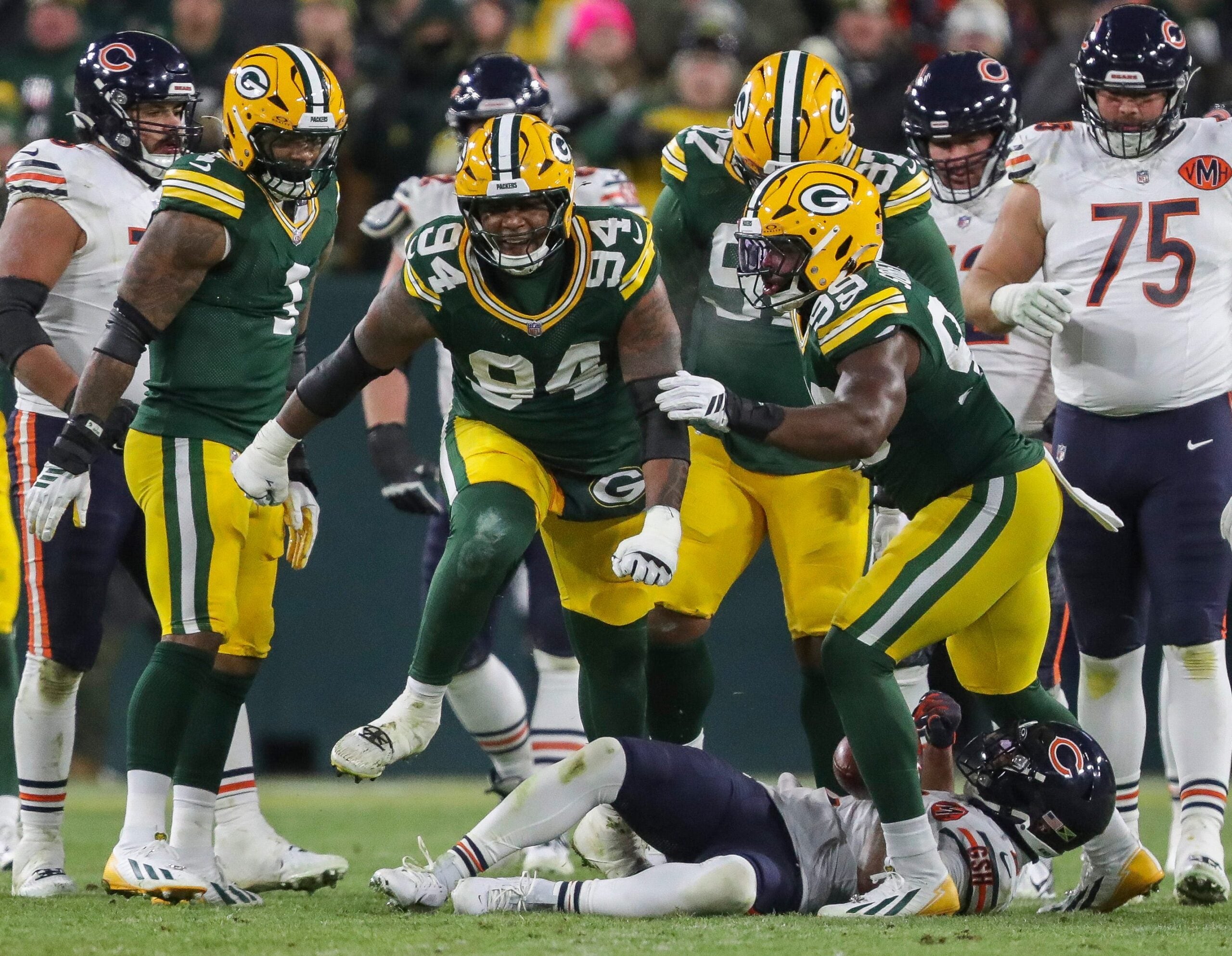 Green Bay Packers defensive end Karl Brooks (94) reacts after tackling Chicago Bears wide receiver DJ Moore (2) for a loss on Sunday, December 7, 2025, at Lambeau Field in Green Bay, Wis. The Packers won the game, 28-21.
