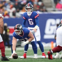 Dec 14, 2025; East Rutherford, New Jersey, USA; New York Giants quarterback Jaxson Dart (6) awaits the snap from center John Michael Schmitz Jr. (61) during the first quarter against the Washington Commanders at MetLife Stadium.