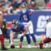 Dec 14, 2025; East Rutherford, New Jersey, USA; New York Giants quarterback Jaxson Dart (6) awaits the snap from center John Michael Schmitz Jr. (61) during the first quarter against the Washington Commanders at MetLife Stadium.